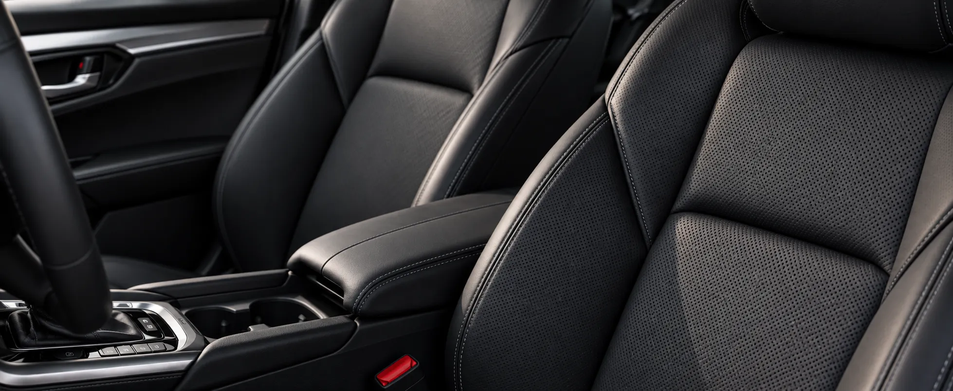 Close-up of a clean car interior, front seats and centre console